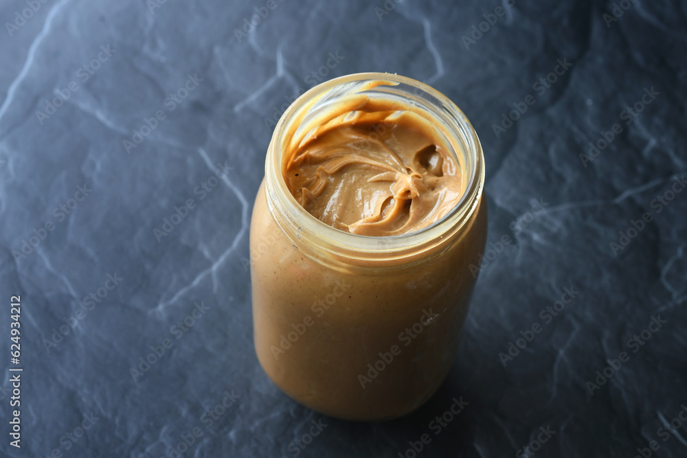 Selective focus of peanut butter jar with no label. January 24 is National Peanut Butter Day Selective focus of peanut butter jar with no label. January 24 is National Peanut Butter Day