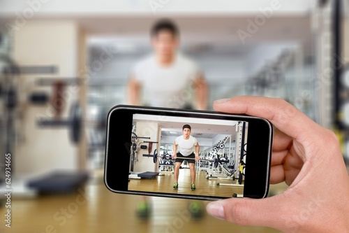 social media concept, young influencer with phone streaming workout