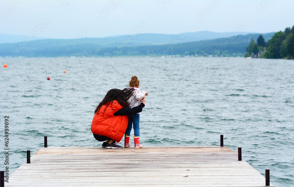 Woman and Kid Having Fun on a Lake Background  .Family Portrait in the Nature 