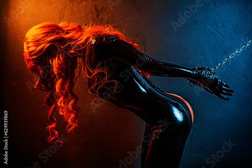 Bdsm style woman in black latex with chained hands photo