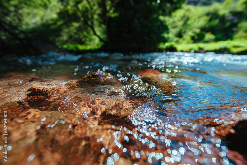 Foto Mountain stream with clean pure water, front focus