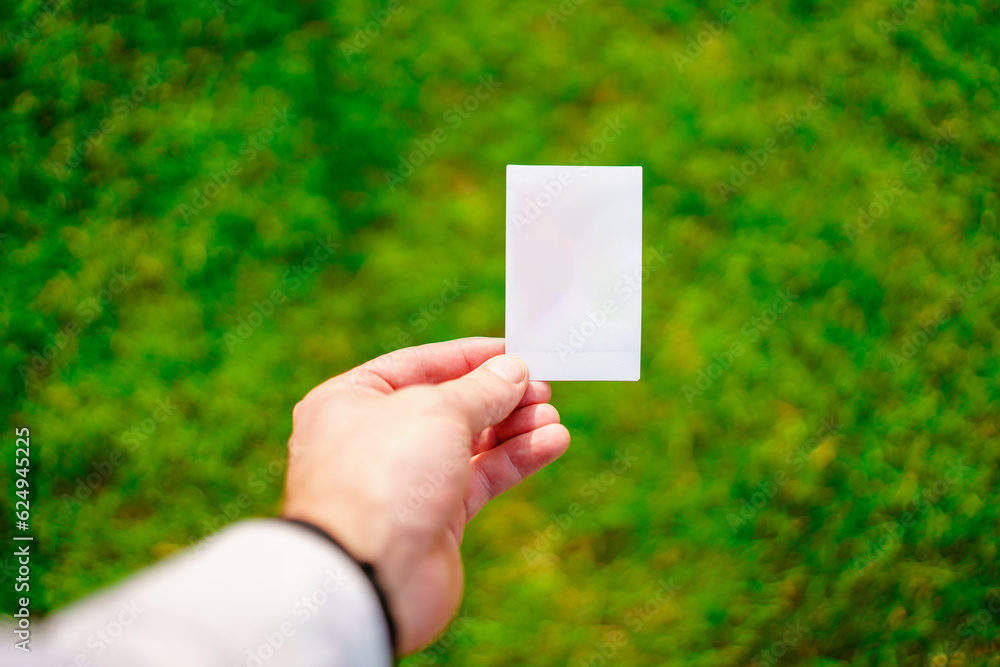 Blank white card on the background of a green lawn. Blank white card on the background of a green lawn.