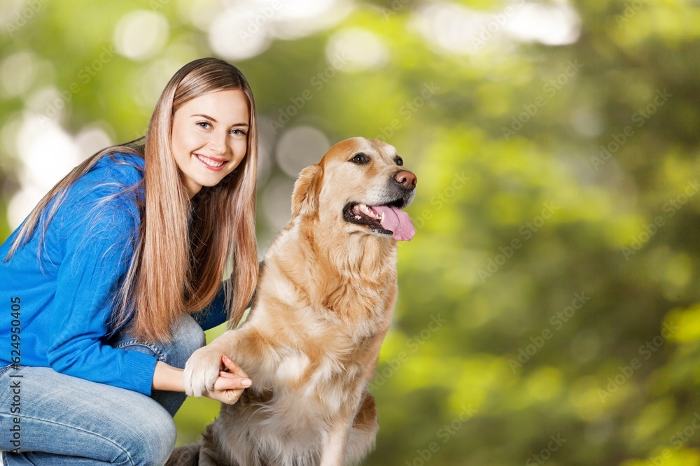 Young happy woman playing with dog in park. Young happy woman playing with dog in park.
