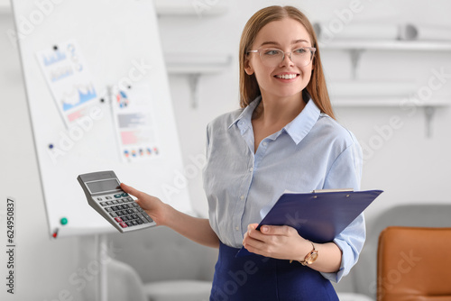 Female accountant with calc...