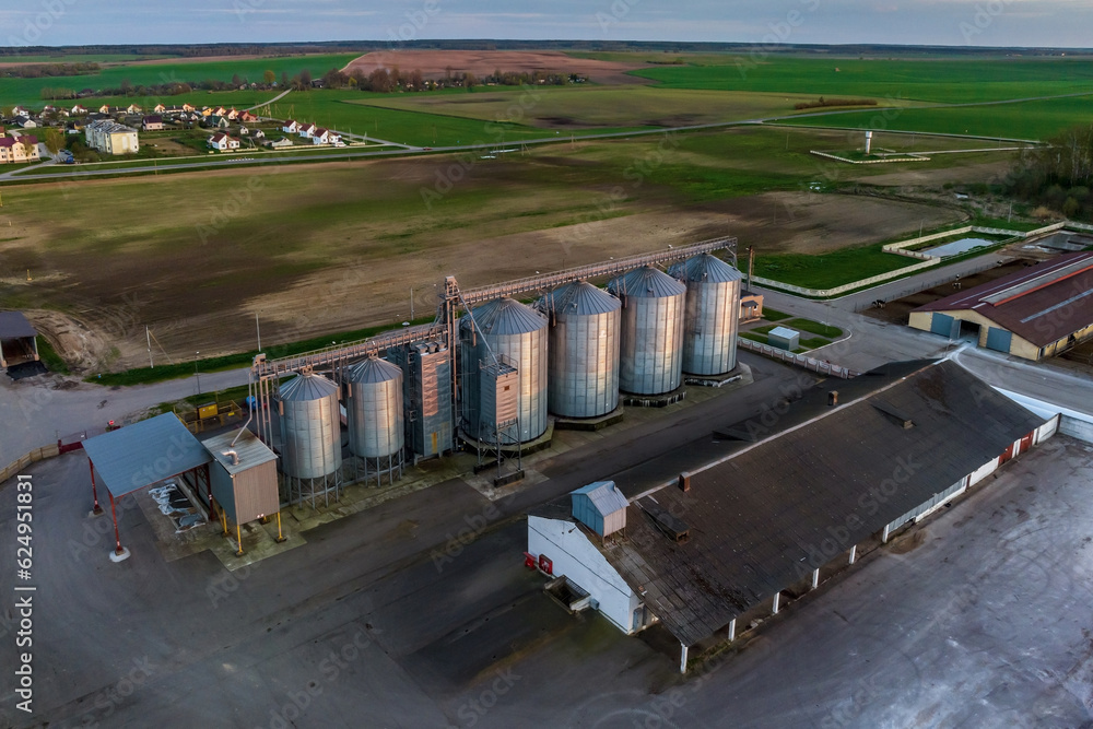 aerial panoramic view on agro-industrial complex with silos and grain drying line for drying cleaning and storage of cereal crops aerial panoramic view on agro-industrial complex with silos and grain drying line for drying cleaning and storage of cereal crops