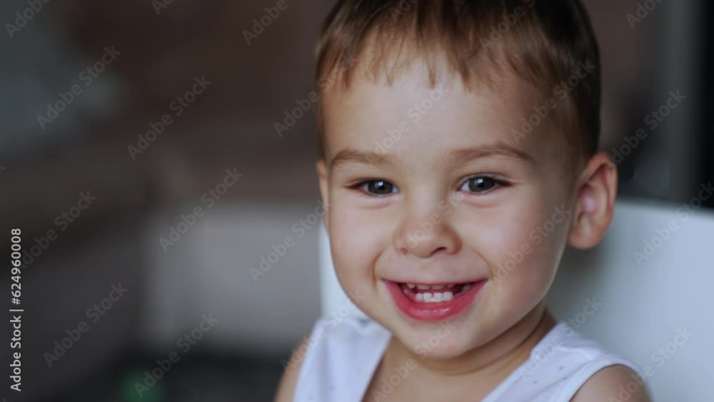 Adorable Caucasian baby boy portrait. Chang of reaction from seriousness to laughter. Close up. Adorable Caucasian baby boy portrait. Chang of reaction from seriousness to laughter. Close up.