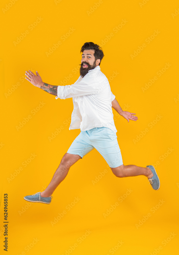 surprised bearded guy in hurry isolated on yellow. bearded guy in hurry at studio.
