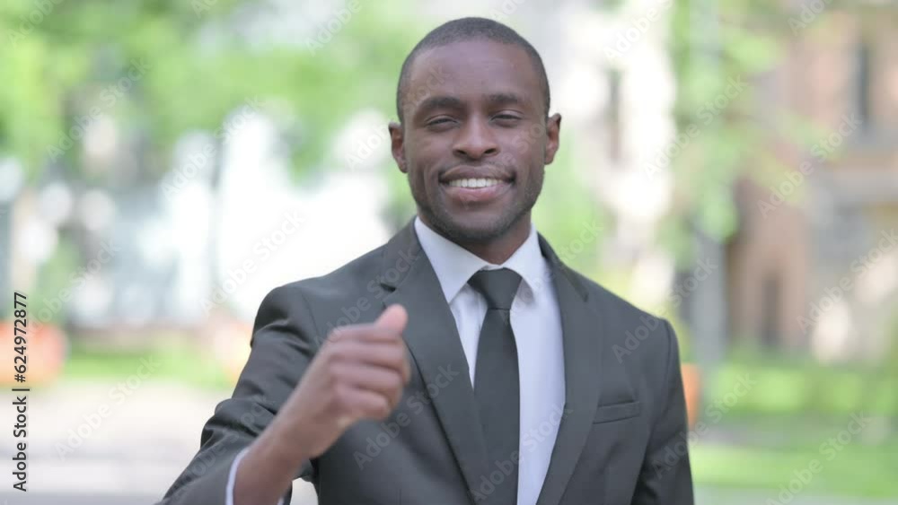Outdoor Portrait of African Businessman Doing Thumbs Up Outdoor Portrait of African Businessman Doing Thumbs Up