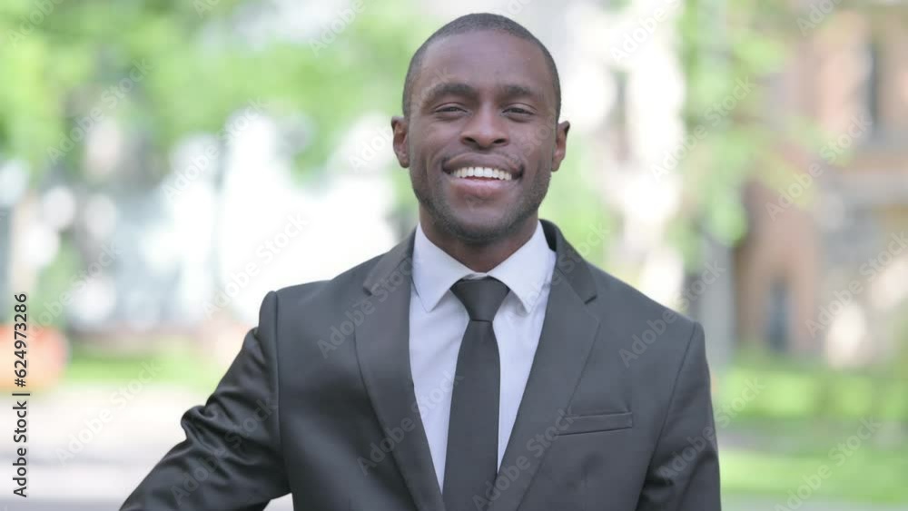 Outdoor Portrait of African Businessman Waving to Say Hello