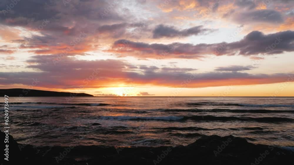 Wide angle of waves on a cliff at sunset Wide angle of waves on a cliff at sunset