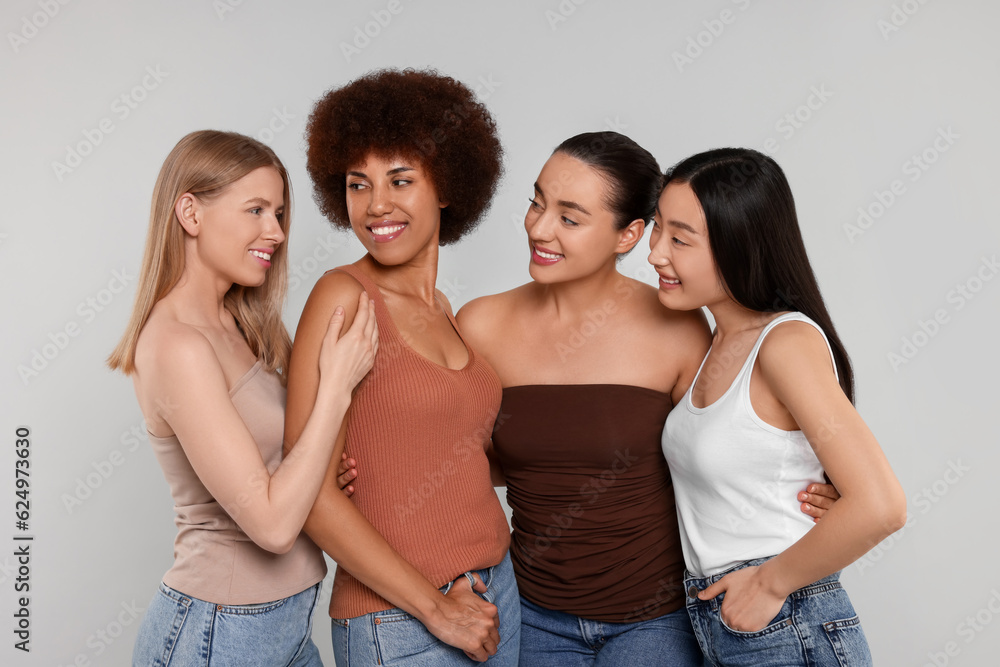 Portrait of beautiful young women on light grey background Portrait of beautiful young women on light grey background