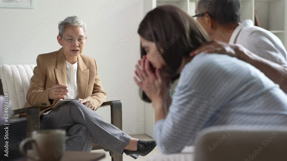 Mature Asian couple consulting couple relationship counselling to solve problems Mature Asian couple consulting couple relationship counselling to solve problems