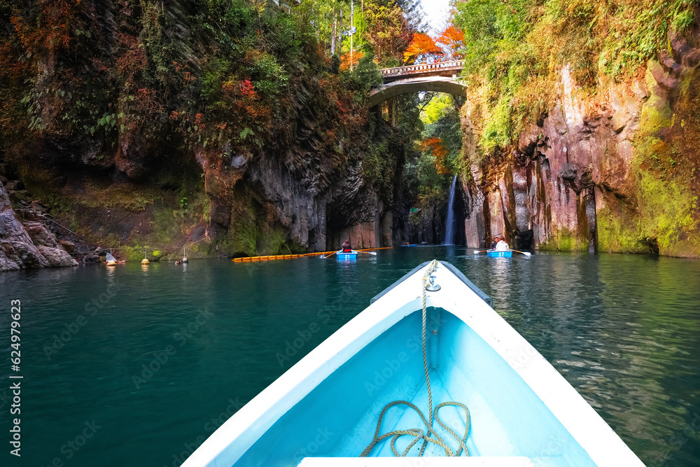 Fototapeta premium Miyazaki, Japan - Nov 24 2022: Takachiho Gorge is a narrow chasm cut through the rock by the Gokase River, plenty activities for tourists such as rowing and trekking through beautiful nature