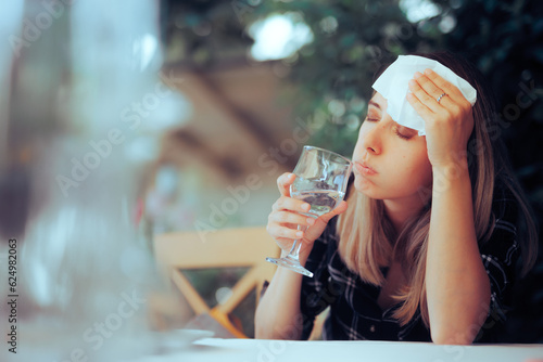 Dehydrated Woman Feeling Hot and Thirsty Drinking Water. Person suffering from dehydration, thirst while sweating in heated summer 