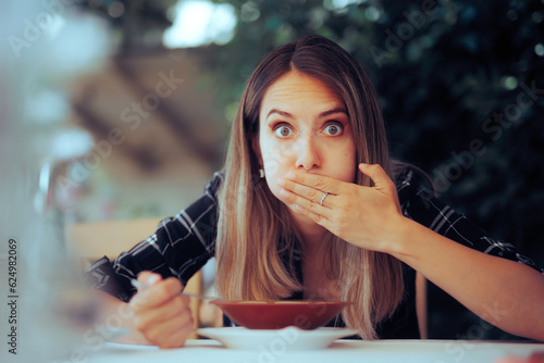 Woman Trying Food Feeling Sick Instantly from first Chewing. Restaurant customer Feeling nauseated and displeased with the serving 