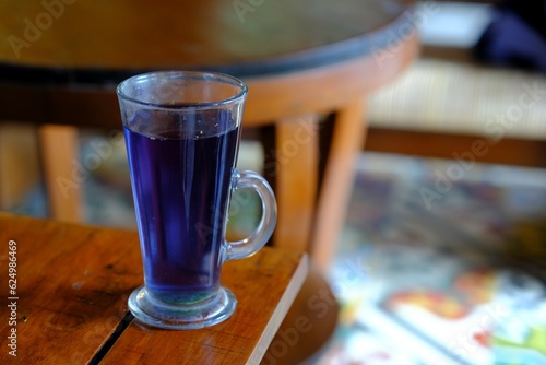 Butterfly pea tea with in the glass. The tea consist of butterfly pea, pandan leaf, lemongrass. Teh bunga telang photo