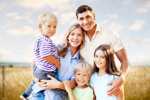 Happy young family with children in nature park