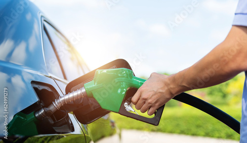Mand hand refilling the car with fuel