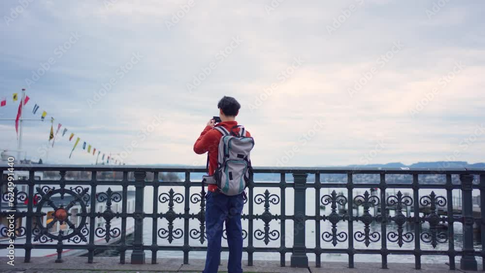 Asian backpacker use camera taking a picture of beautiful landscape. Asian backpacker use camera taking a picture of beautiful landscape.