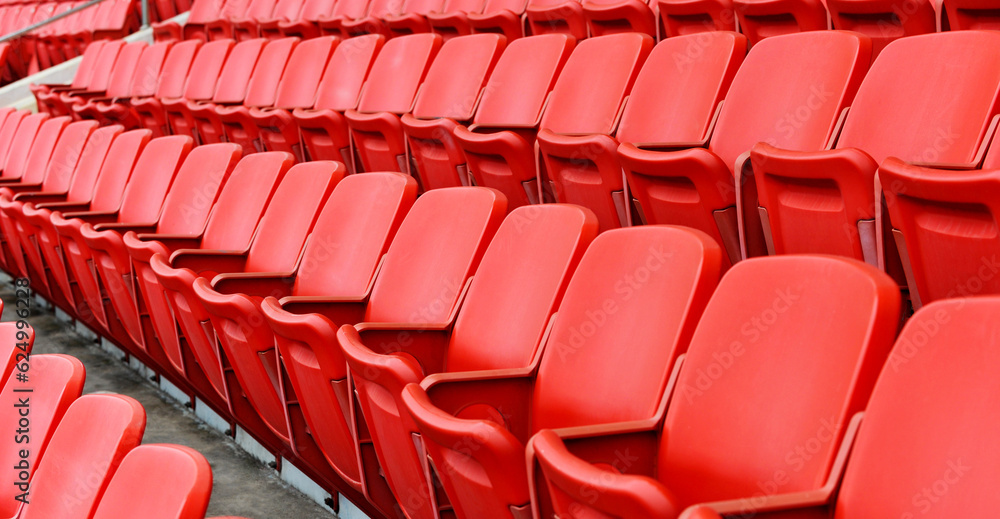 Rows of red seats in a stadium Rows of red seats in a stadium