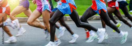 Side view of athletes running in a cross country race