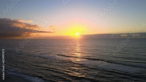 Drone shot of a sunrise at a beach in Cariló, Argentina. Drone flying towards the sun rising over the Atlantic Ocean. photo