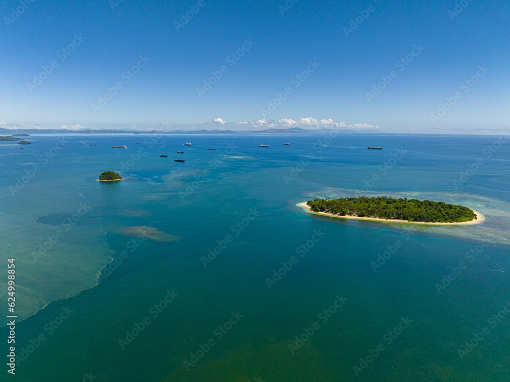 Aerial view of tropical island with white sandy beach. Mindanao, Philippines.