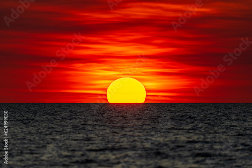 Dramatic sunset on the horizon at Mindil Beach, somewhat resembling the Australian Aboriginal flag. Darwin, Australia. © Trung Nguyen