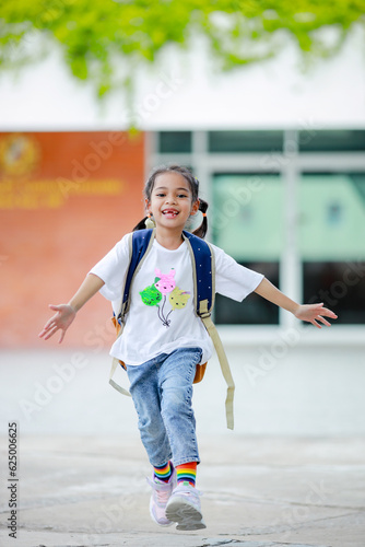 Wallpaper Mural Little kid girl asian with a backpack going to school with fun. which increases the development and enhances the learning skills. Concept Back to school. Torontodigital.ca