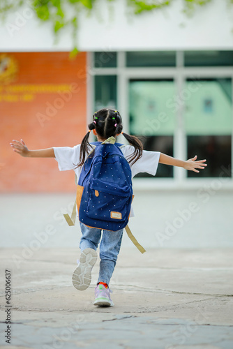 Little kid girl asian with a backpack going to school with fun. which increases the development and enhances the learning skills. Concept Back to school.