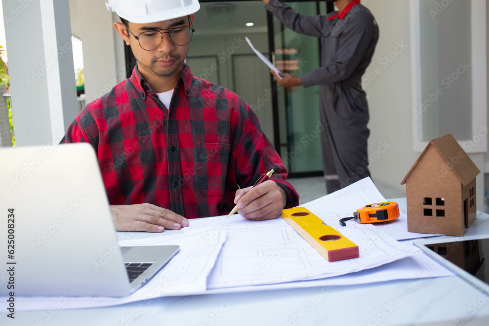 © weerachai - Team Engineer and Architect planing and discuss at Construction Site with blueprint