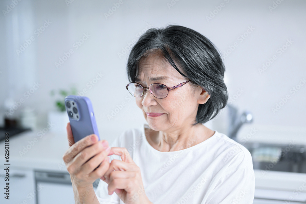 Elderly woman surprised to find a strange website or advertisement on her phone. Elderly woman surprised to find a strange website or advertisement on her phone.