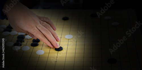 Detail of woman hand playing chinese boardgame photo