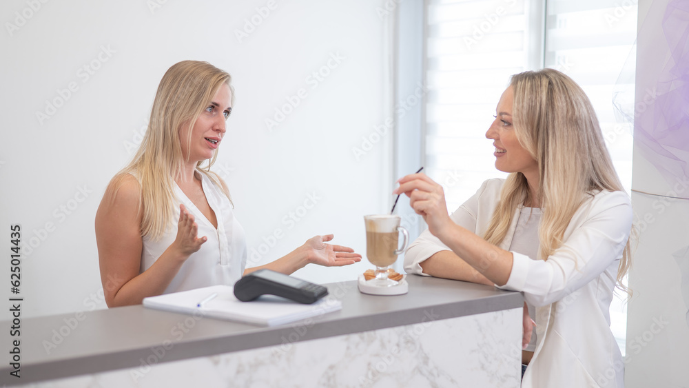 Receptionist in a beauty salon prepares coffee for a client. Receptionist in a beauty salon prepares coffee for a client.