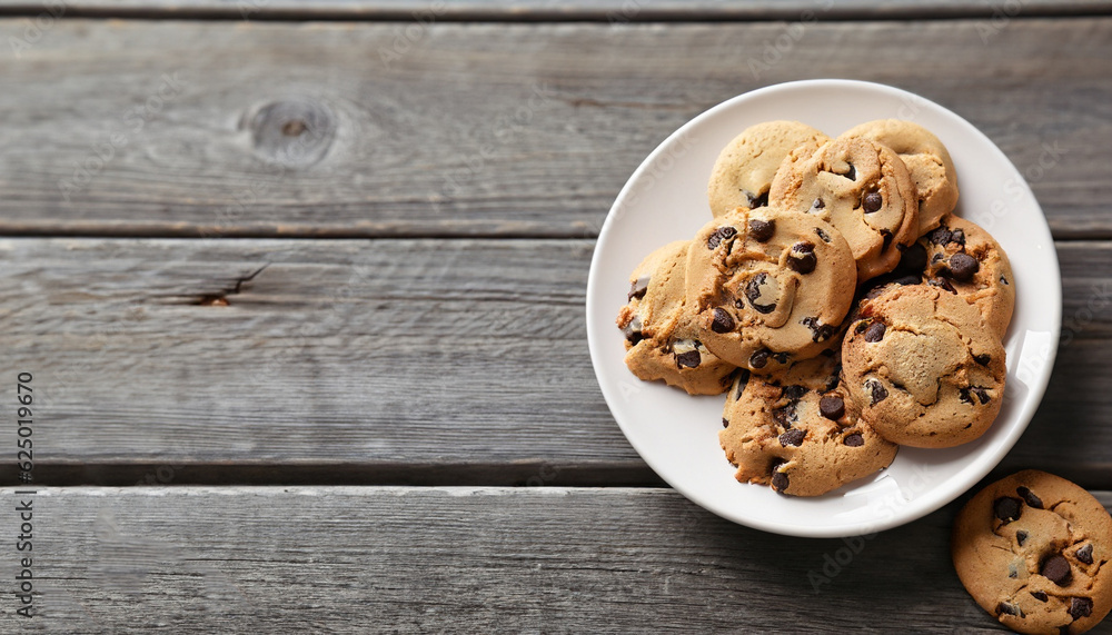 Chocolate chip cookies on plate on grey wooden background Chocolate chip cookies on plate on grey wooden background