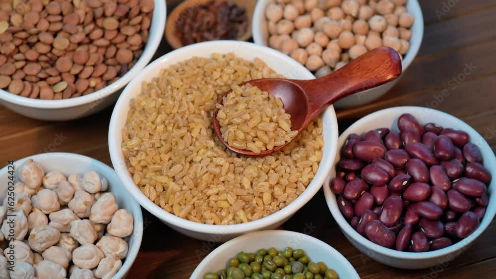 Legumes, lentils, chickpeas, bulgur and beans assortment. Rotation top view. 4K Legumes, lentils, chickpeas, bulgur and beans assortment. Rotation top view. 4K