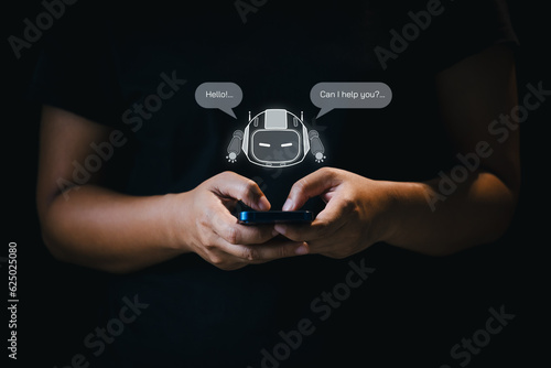 Hand using smartphone chatting with chatbot. Artificial Intelligence technology respond online messages to help customers. Futuristic technology, Virtual assistant on internet.