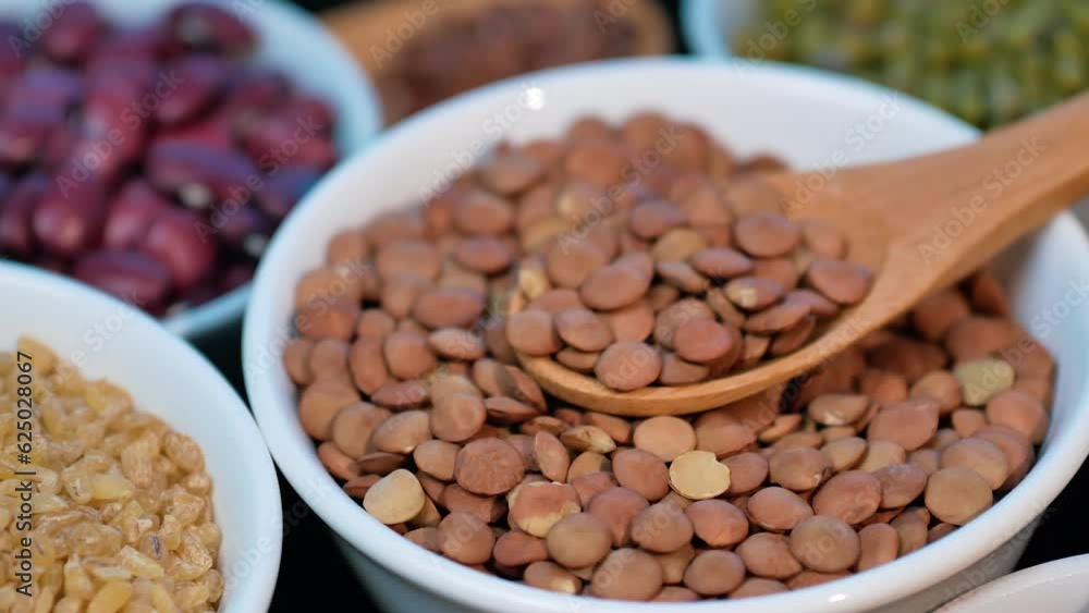 Legumes, lentils, chickpeas, bulgur and beans assortment. Rotation on a bamboo table. Legumes, lentils, chickpeas, bulgur and beans assortment. Rotation on a bamboo table.