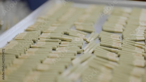 motion shot over Pre-roll Cannabis joints on metal tray, Close-up  photo