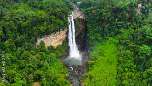 Jungle Waterfall in a tropical forest surrounded by green vegetation. Laxapana Falls, Sri Lanka. photo