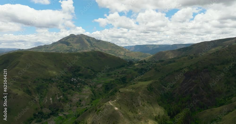 Aerial view of mountains with green forests and farmland with farm plantations. Sumatra, Indonesia. Aerial view of mountains with green forests and farmland with farm plantations. Sumatra, Indonesia.