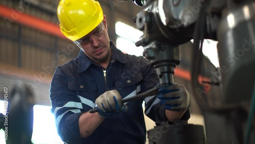 Senior professional mechanical engineer or technician working in the heavy metal work machine in a factory. 