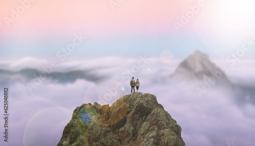 Girl and boy standing on the top of a cliff above the clouds holding hands each other-sunlight-beautiful scenery