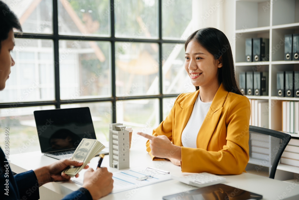 Signing a contract. Client and broker agent, lease agreement, successful deal and Young business sitting at the desk in office . Signing a contract. Client and broker agent, lease agreement, successful deal and Young business sitting at the desk in office .