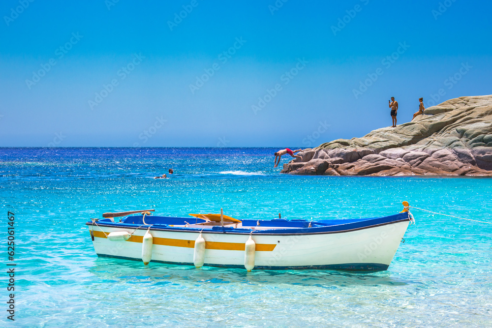 Beautiful sunny coast view to an amazing paradise holiday bay with crystal clear blue water sandy beach, Seychelles, Ikaria island, Greece.