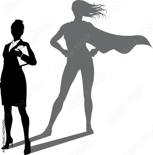 A superhero business woman revealed by her shadow silhouette as a super hero in a cape