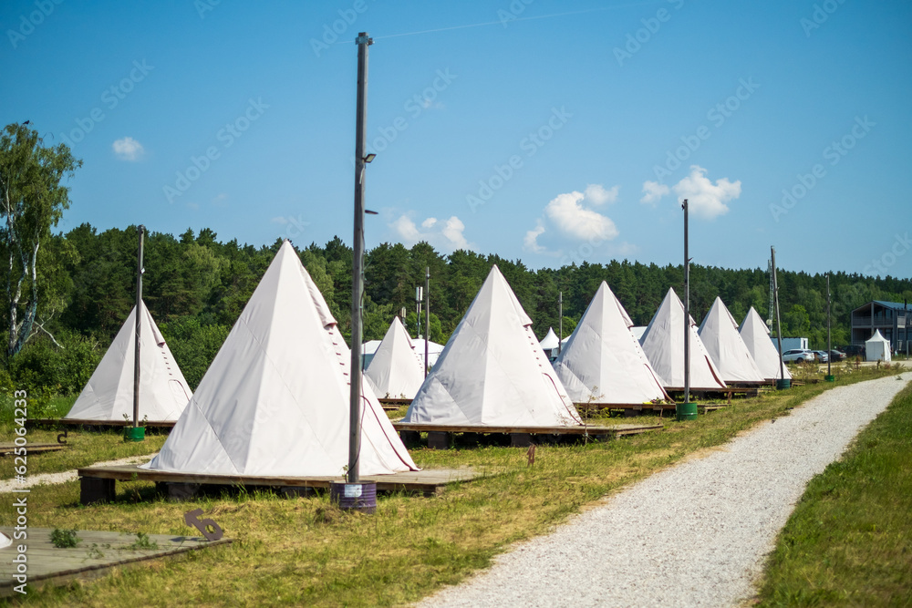 White tents in field ready for event