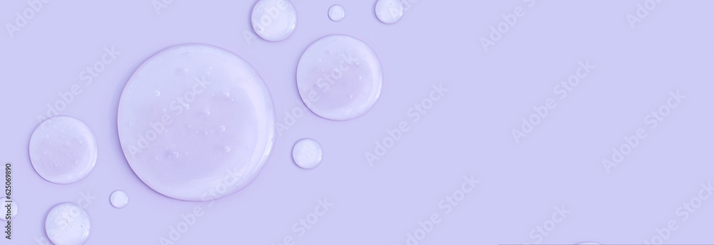 round drops of transparent gel serum on a pastel background