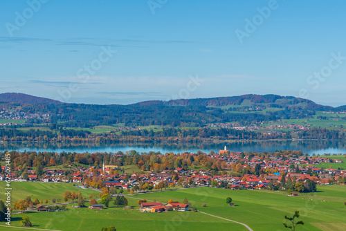 lake mountains and european town with blue sky in autumn time