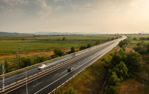 Aerial panoramic photo from above with A1 highway road between Sebes and Deva. Drone photo with the roads of Romania. Aerial view during sunset after a summer storm.